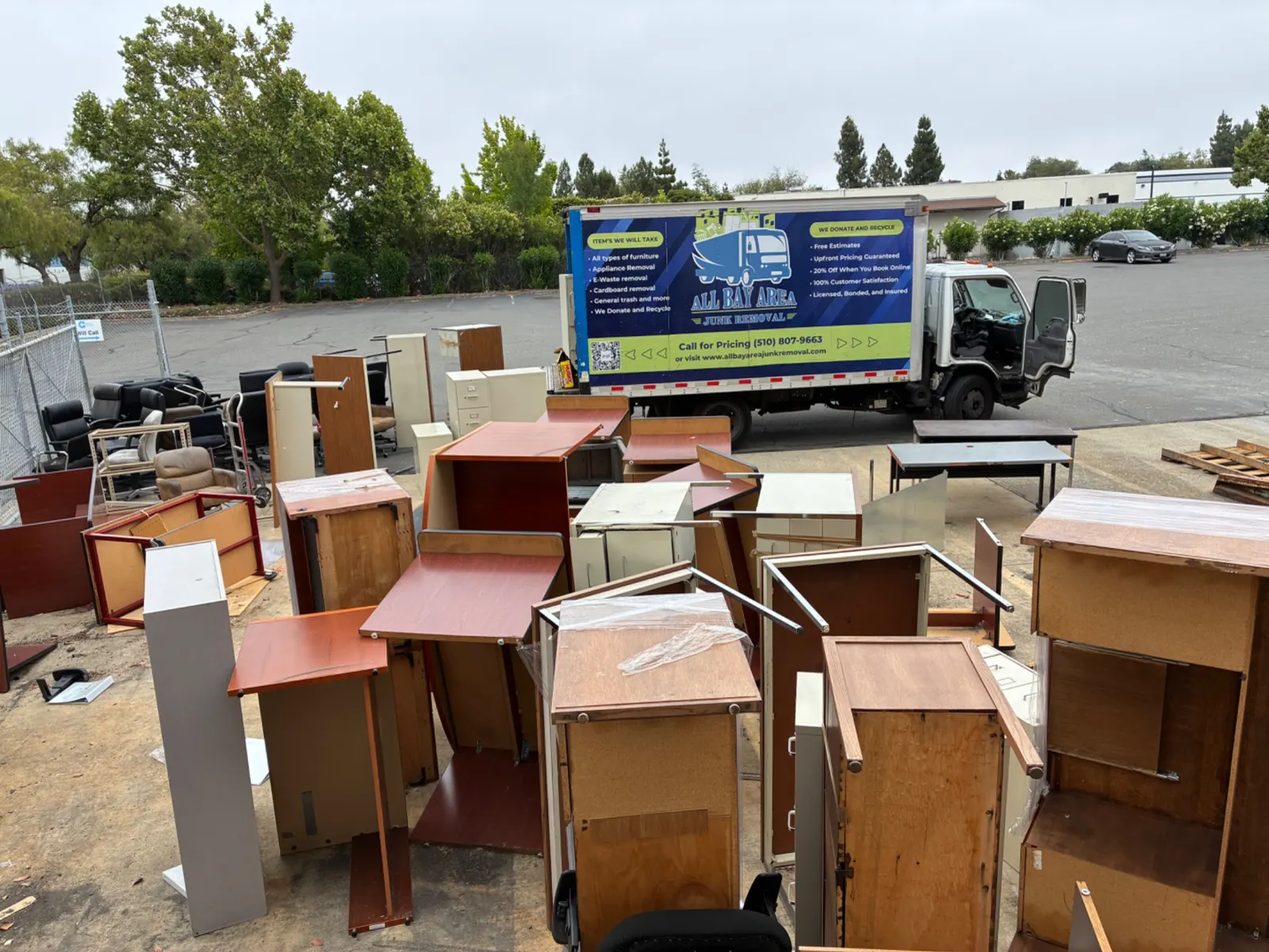 Office furniture lined up for removal next to the company truck